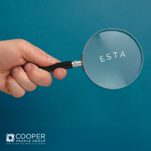 A hand holding a magnifying glass over the word ESTA
