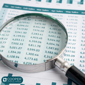 magnifying glass over sheet with numbers